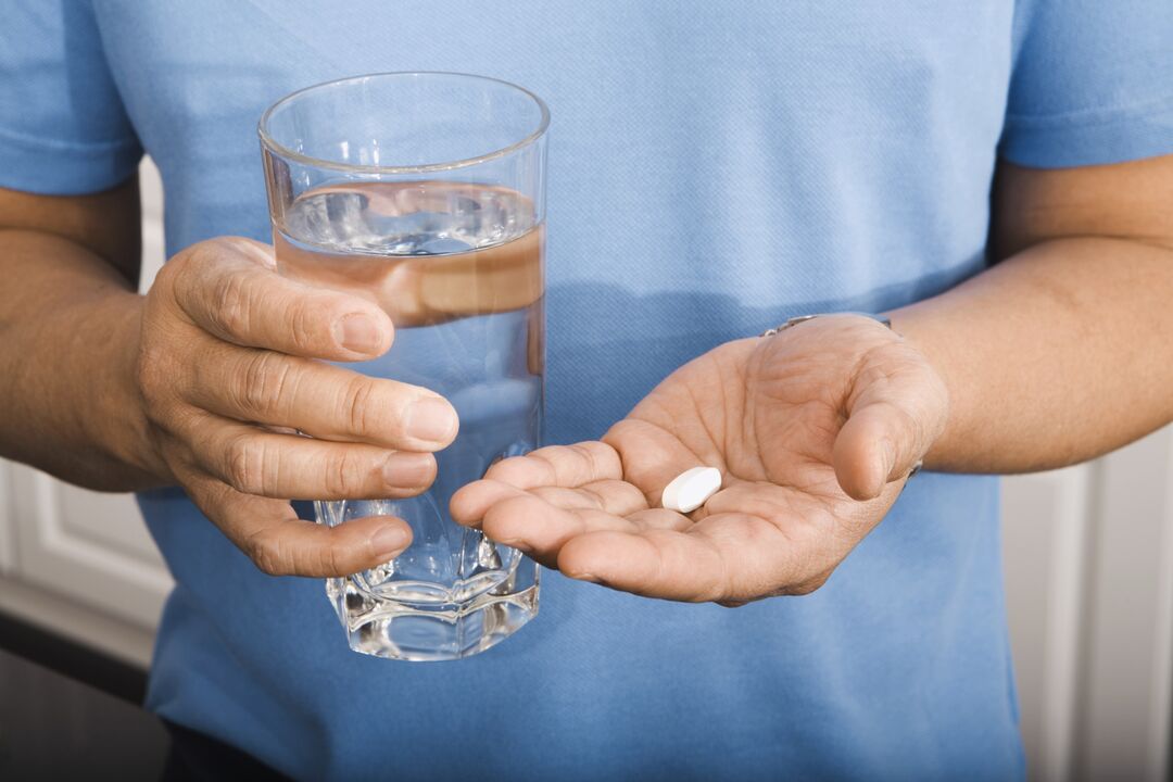 a man drinking an anti-parasite pill